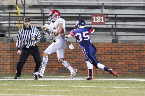 Escambia Academy's Maleek Salter (12) hauls in a pass as Dustin Jenkins (35) closes in during the AISA Class AAA State Championship Game help Friday, November 21, 2014 at Troy University's Veterans Memorial Stadium. Bessemer leads Escambia at the half, 14-7. (Photo/Joey Meredith)