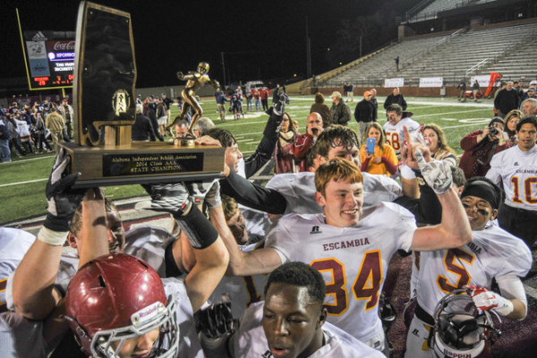 Escambia Academy raises the trophy in celebration after winning the AISA Class AAA State Championship Game Friday, November 21, 2014 at Troy University's Veterans Memorial Stadium. Escambia Academy came from behind in the fourth quarter to win 35-28. (Photo/Joey Meredith)