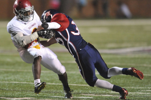 Escambia Academy's Kris Brown (6) is tackled by Bessemer Academy's Dustin Jenkins (35) during the AISA Class AAA State Championship Game Friday, November 21, 2014 at Troy University's Veterans Memorial Stadium. Escambia Academy came from behind in the fourth quarter to win 35-28. (Photo/Joey Meredith)